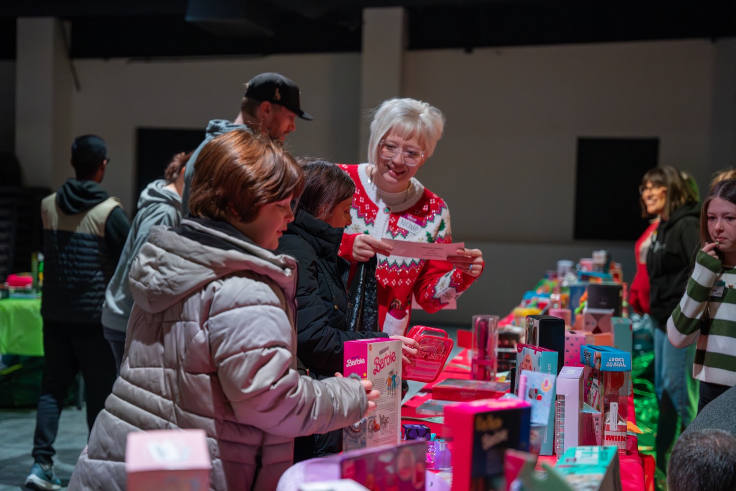 People choosing gifts from tables of toys at the Christmas Give Back