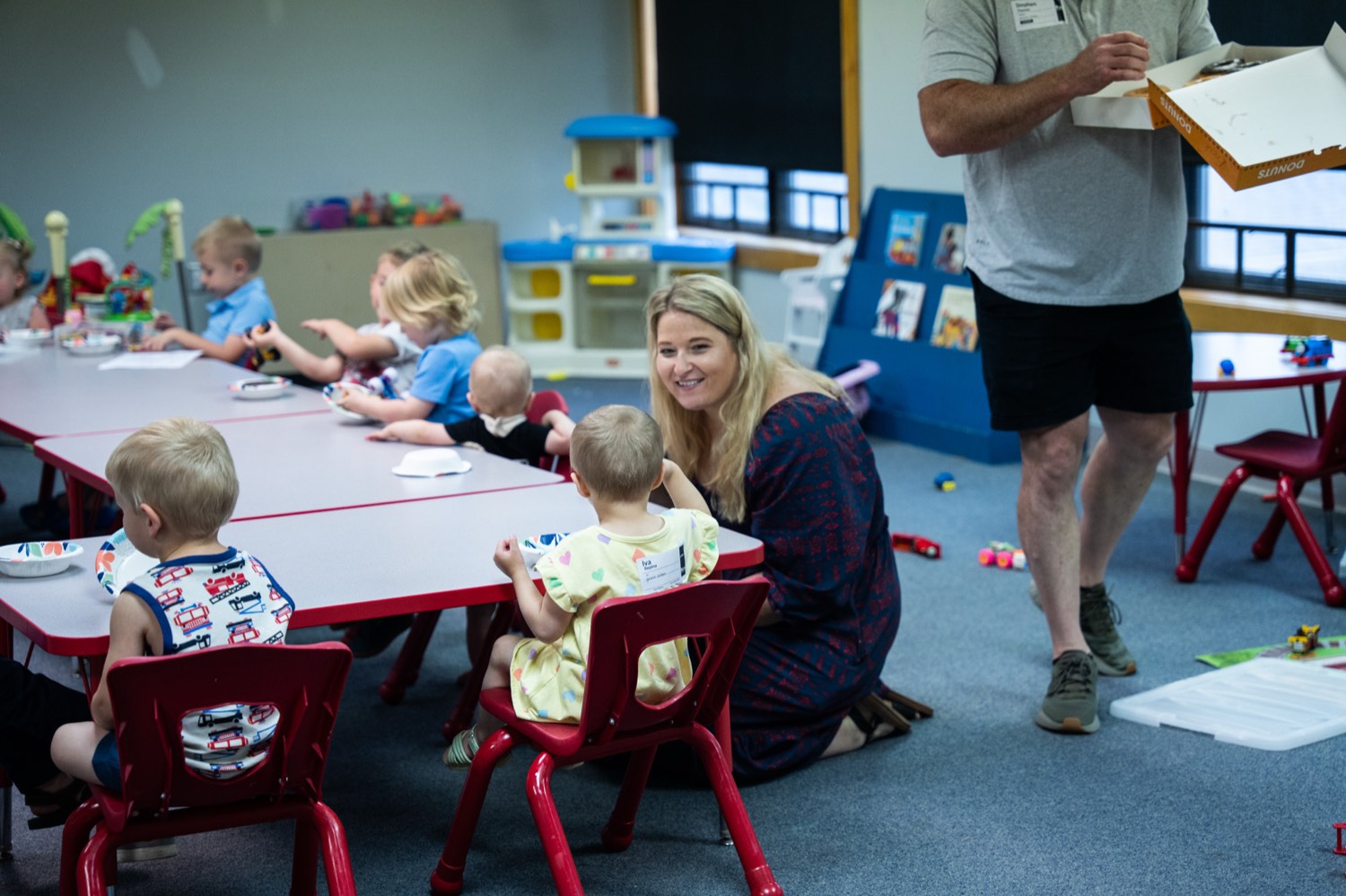 Toddlers and a leader around a low table at the Springfield Dream Center