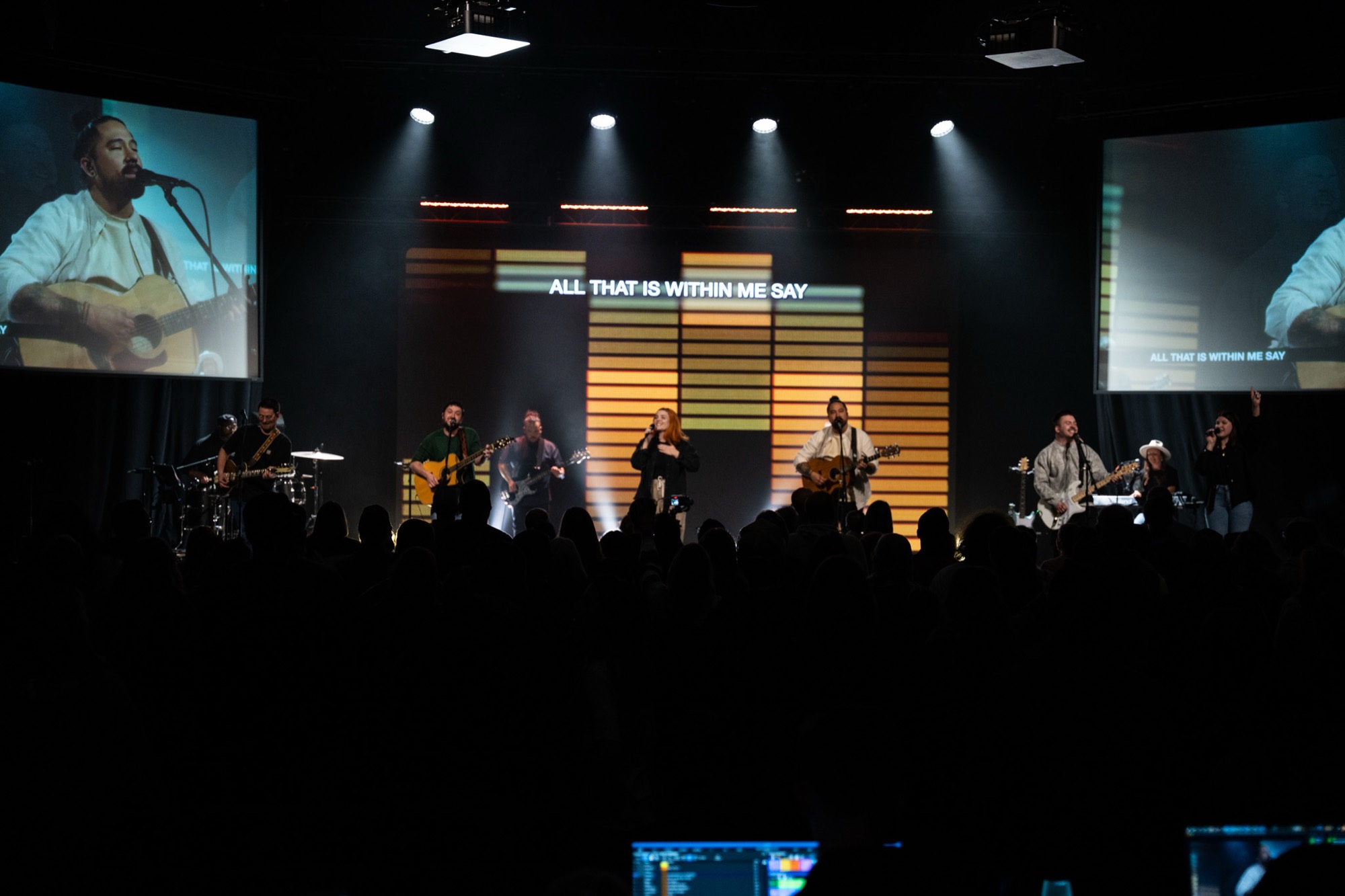 The congregation gathered for worship, the band lit on stage